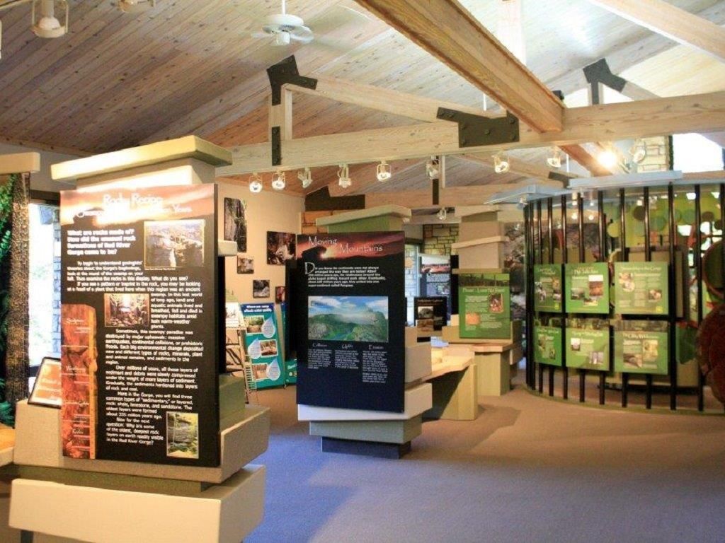 Museum exhibit with information panels and displays on a wooden structure.