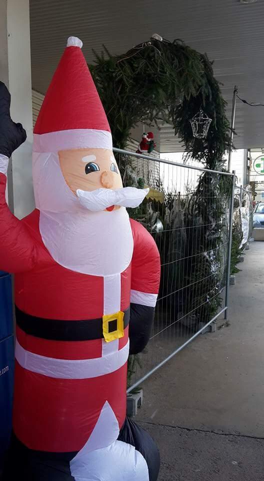 Stand de sapins avec un père Noël gonflable