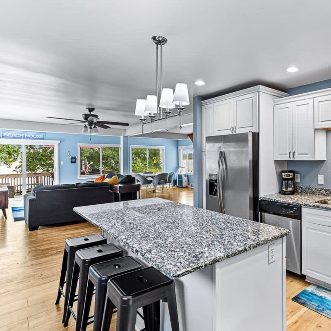 A kitchen with granite counter tops and stainless steel appliances