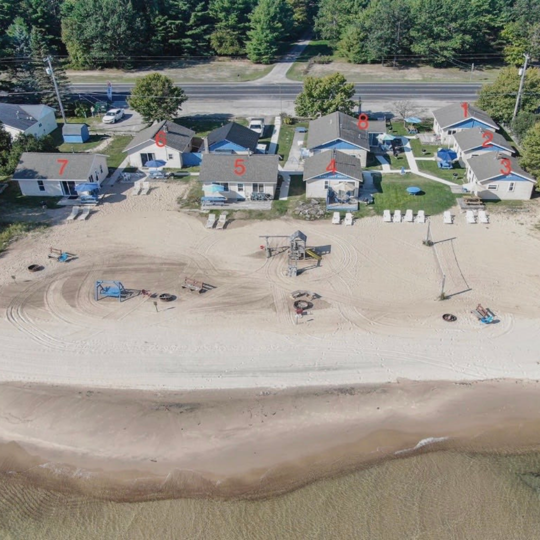 An aerial view of a beach with houses and a road.
