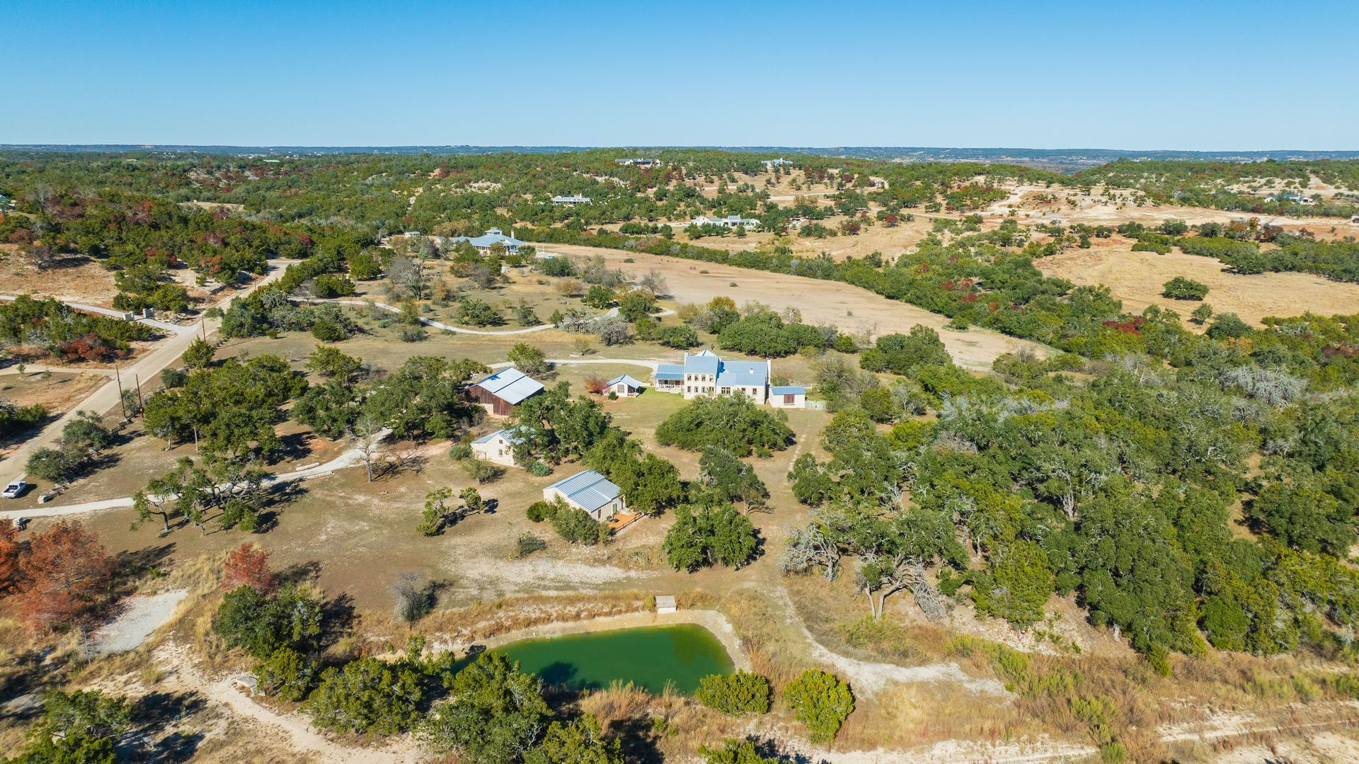 A city skyline at night with a bridge over a body of water.