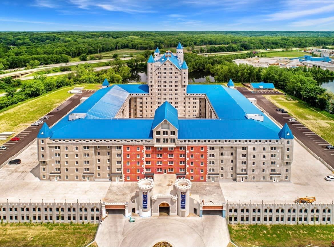 An aerial view of a large building with a blue roof