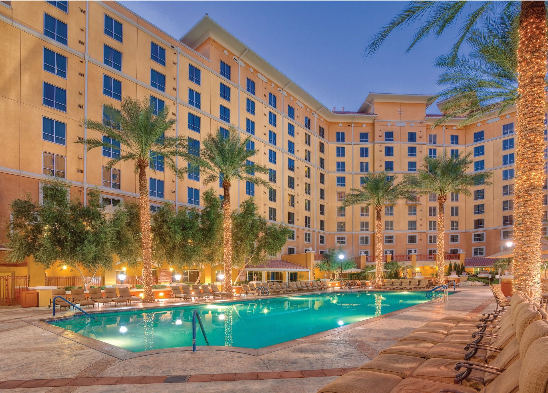 A large building with a swimming pool in front of it