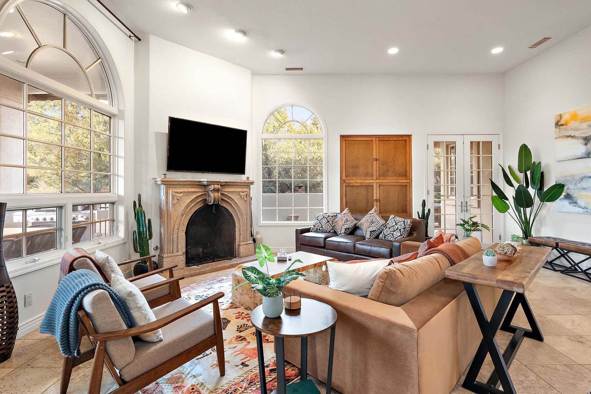 Airbnb living room with natural light, arched windows, and cozy modern decor.