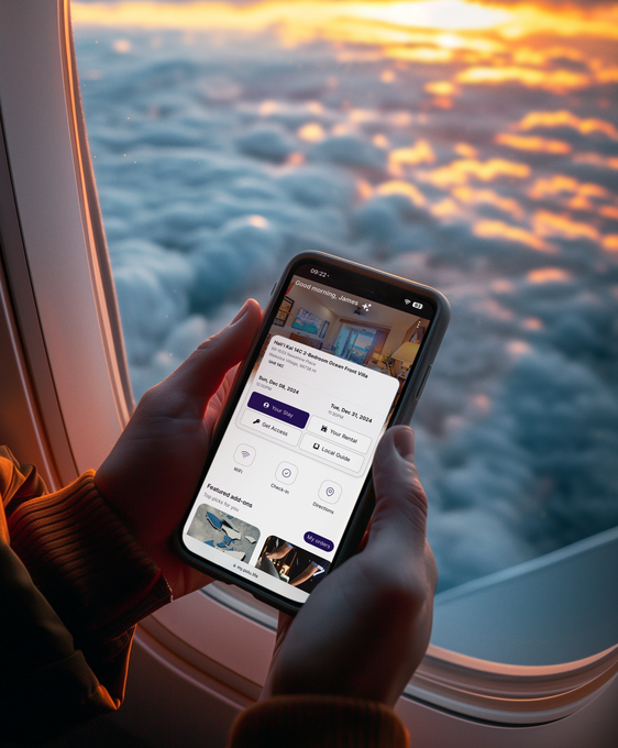 A person holding a cell phone in front of an airplane window