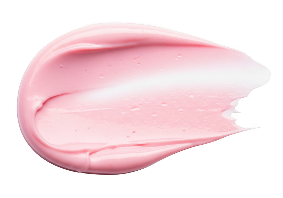 Mancha de crema cosmética rosa sobre un fondo blanco.