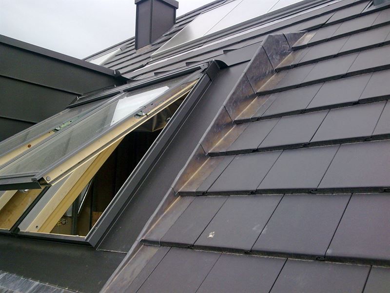 Ein Dach mit einem Fenster und einem Schornstein darauf