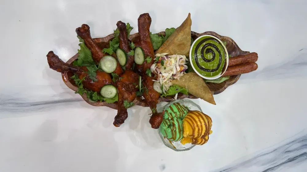 A plate of food with meat and vegetables on a table.