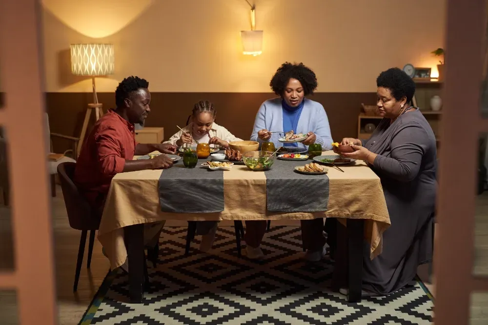 A family is sitting at a table eating dinner together.