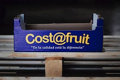 Caja de fruta Blue Cost@fruit en una cinta transportadora