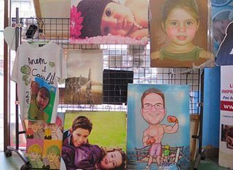 Un montón de cuadros están colgados en un estante en una tienda.