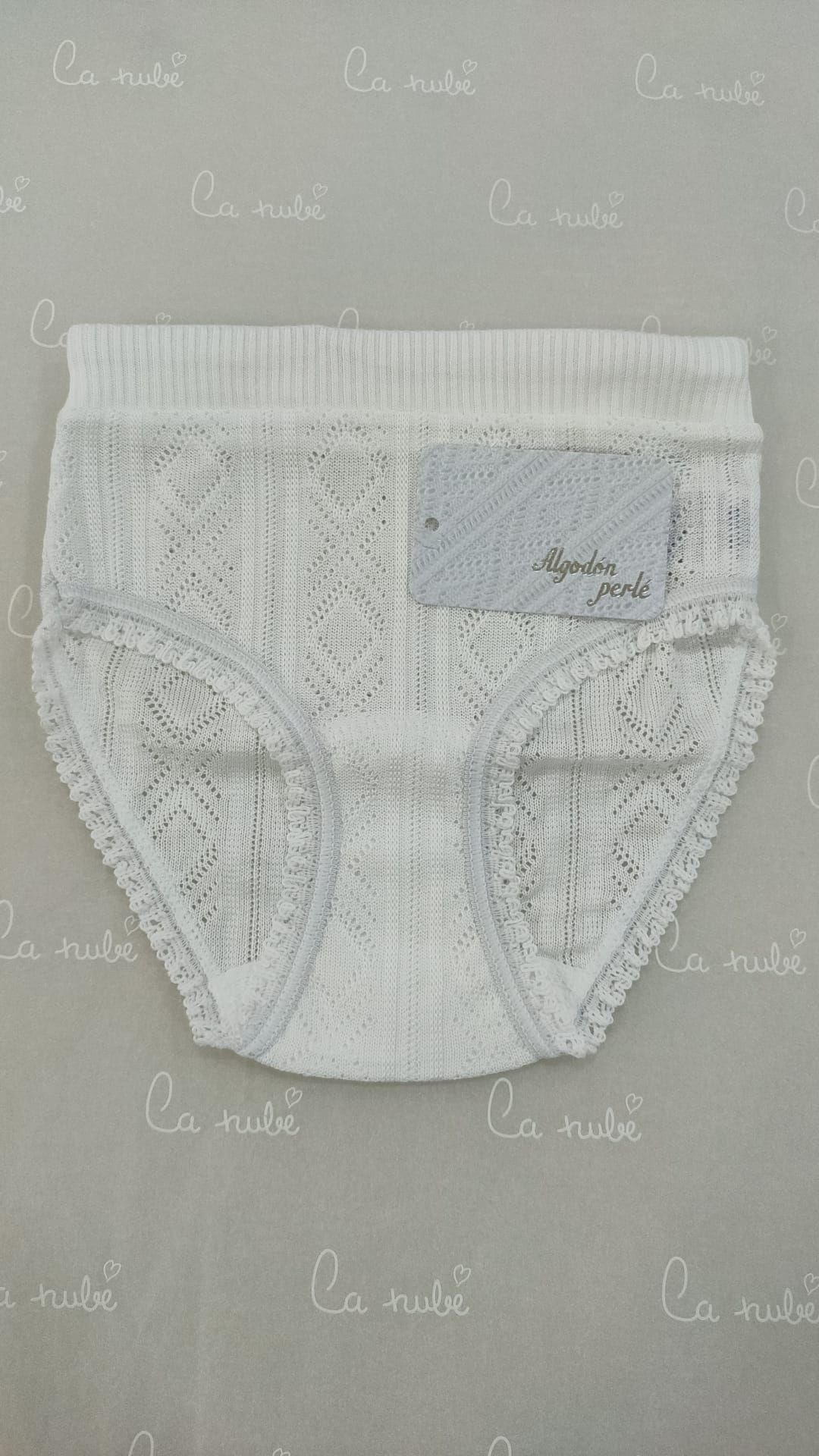 Un par de ropa interior de encaje blanco está sobre una mesa.