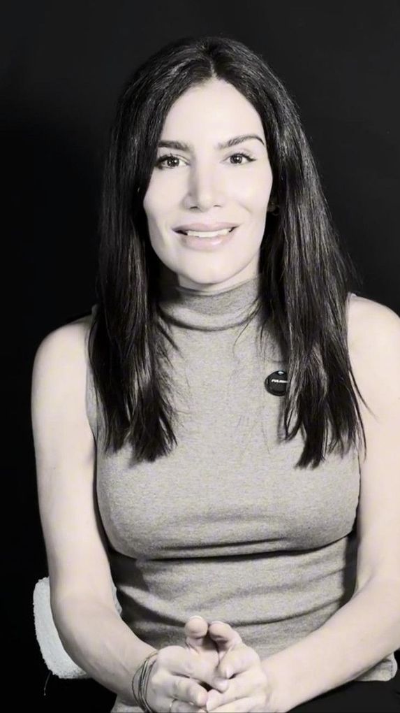 Una mujer que lleva una máscara le está dando a otra mujer un tratamiento facial.