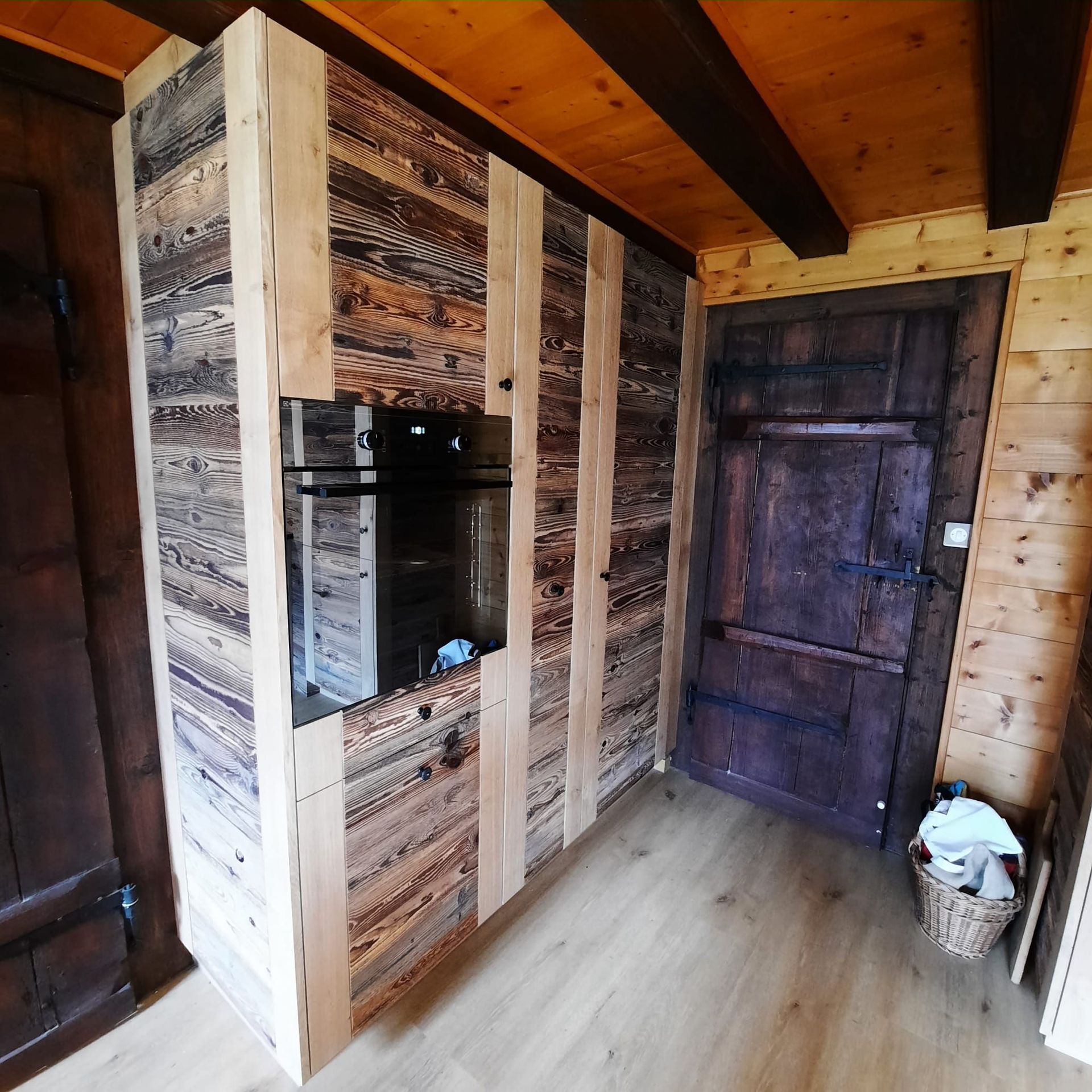 Cuisine vieux bois et chêne. Granit impala flammé brossé . Entre meuble en verre. Petite fenêtre sur mesure