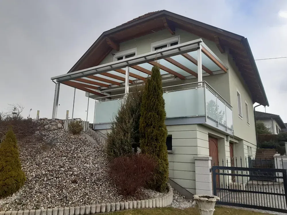 Ein Haus mit einem Balkon und einem Vordach darüber