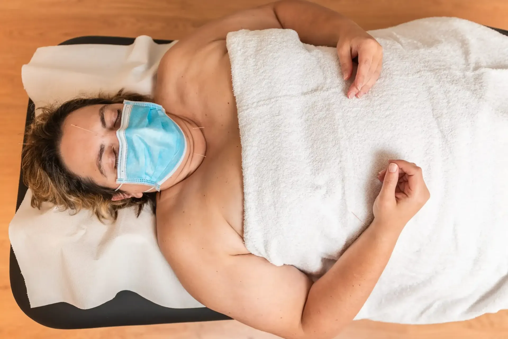 Una persona con una mascarilla quirúrgica azul 