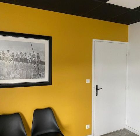 Une pièce avec le mur peint en jaune.