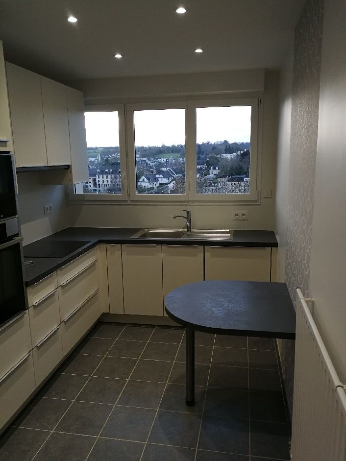 Cuisine dans un appartement avec les meubles blancs.