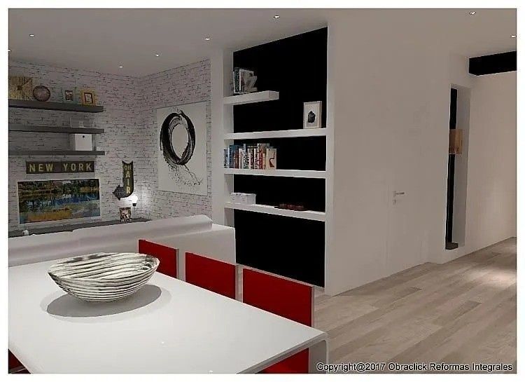 Una mesa de comedor blanca con un cuenco se sitúa frente a una pared con estantes y sillas rojas