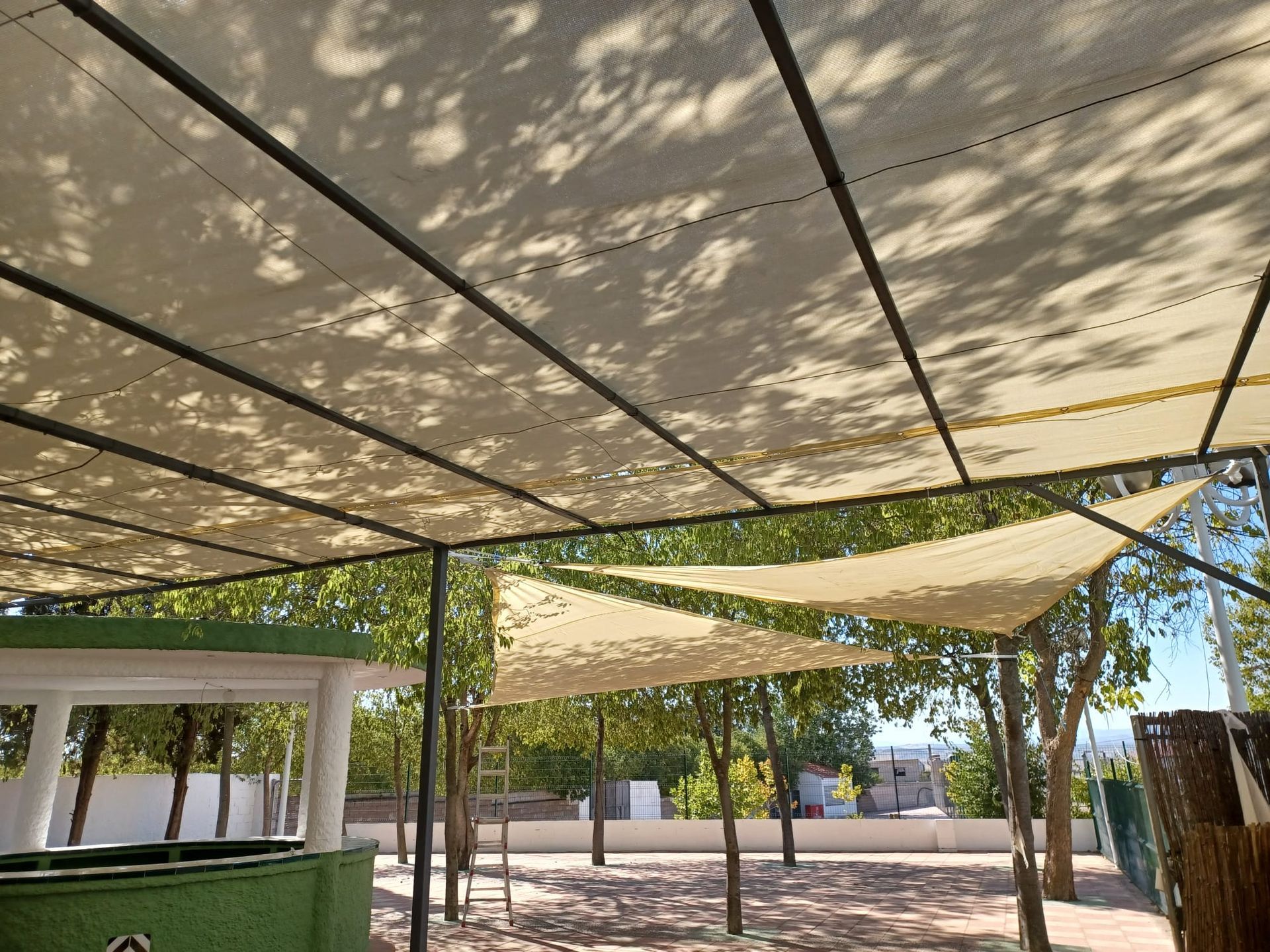 Una mesa bajo un dosel en el patio trasero de una casa