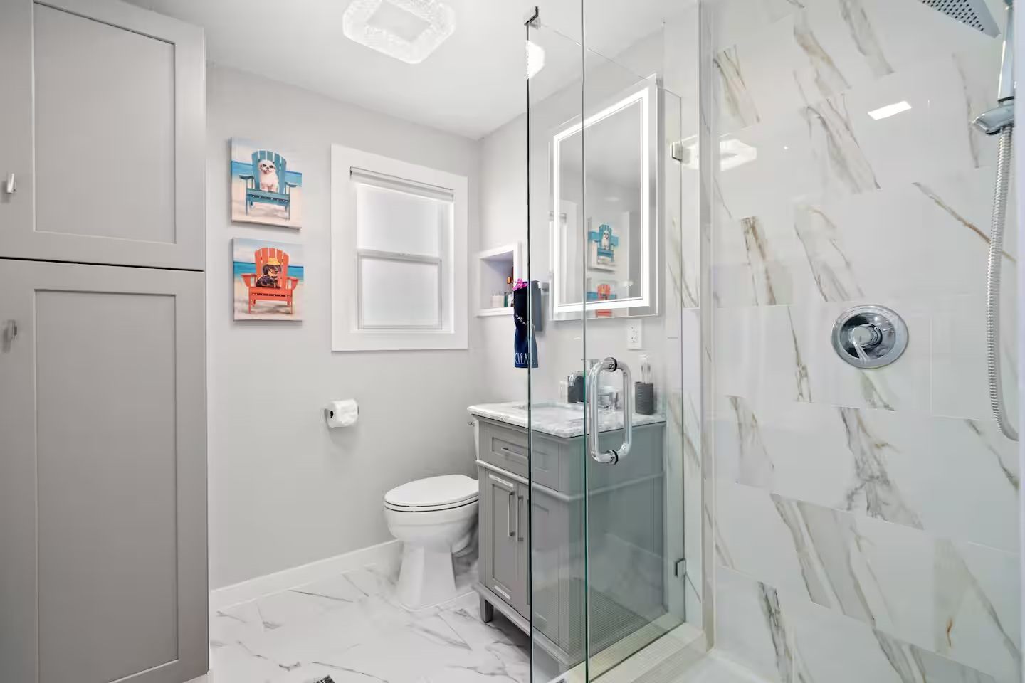 A bathroom with a toilet , sink , shower and mirror.