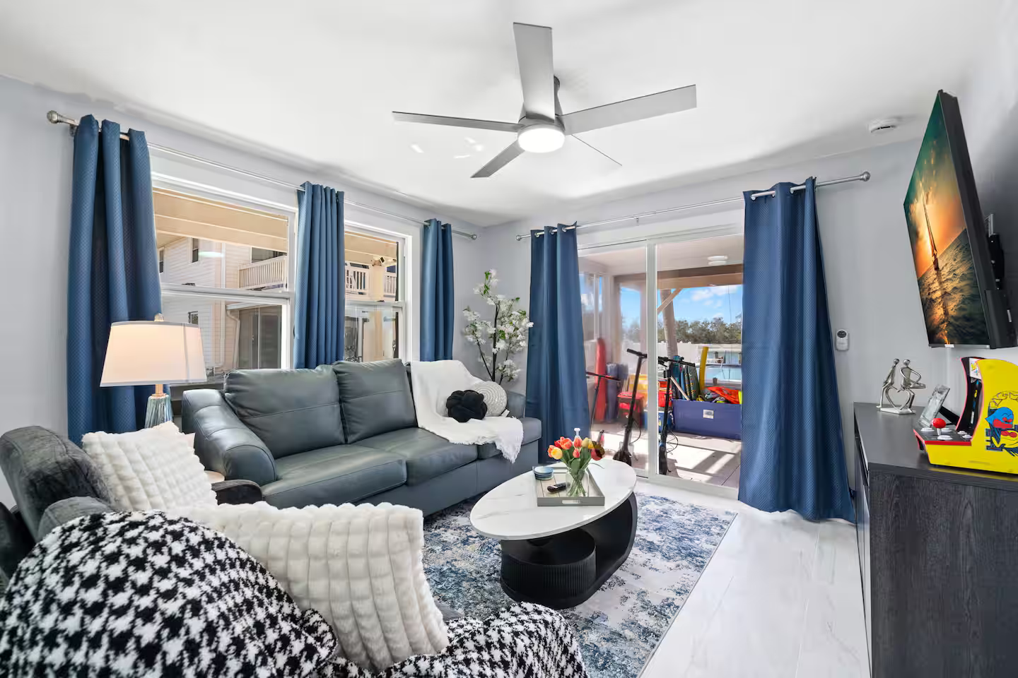 A living room filled with furniture and a ceiling fan.