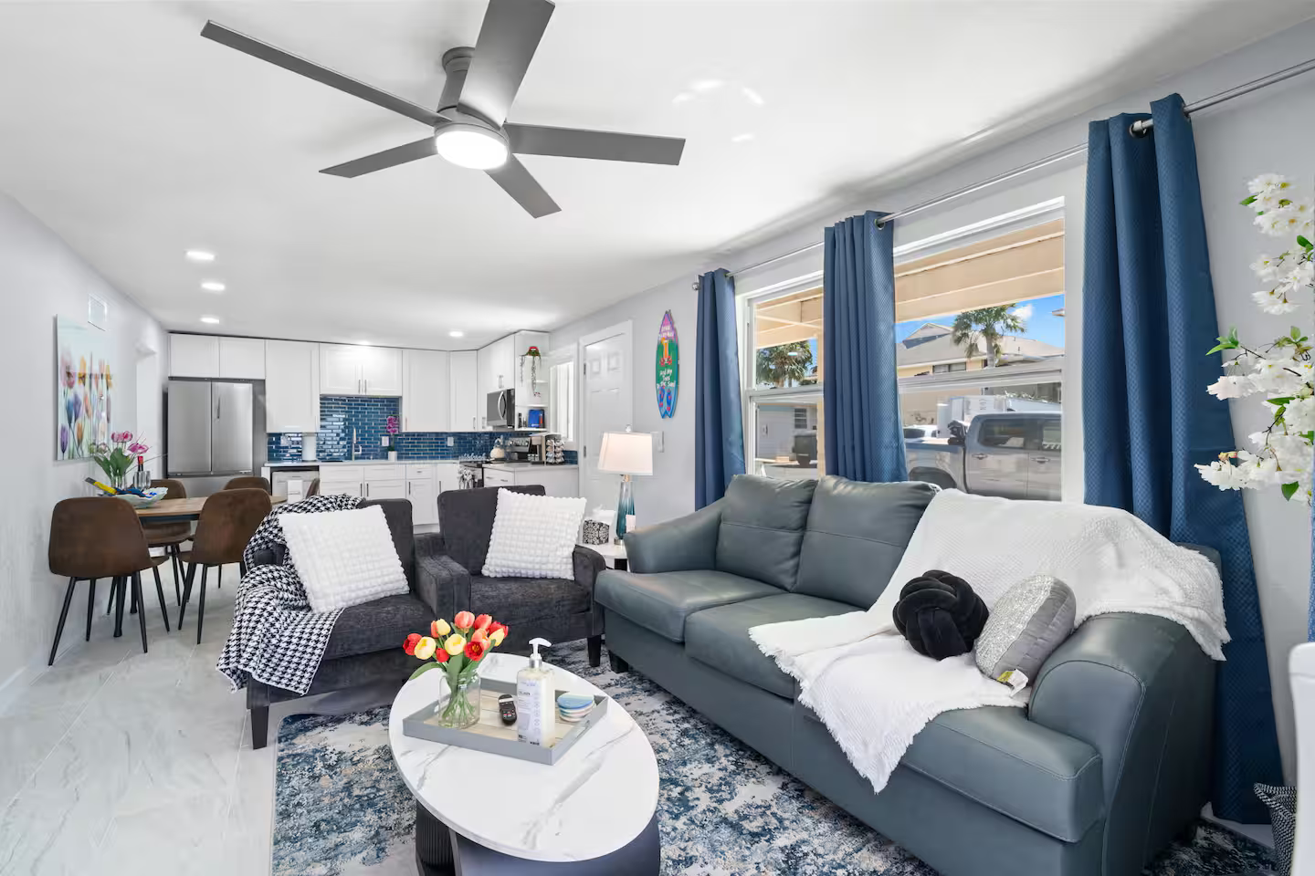 A living room filled with furniture and a ceiling fan.