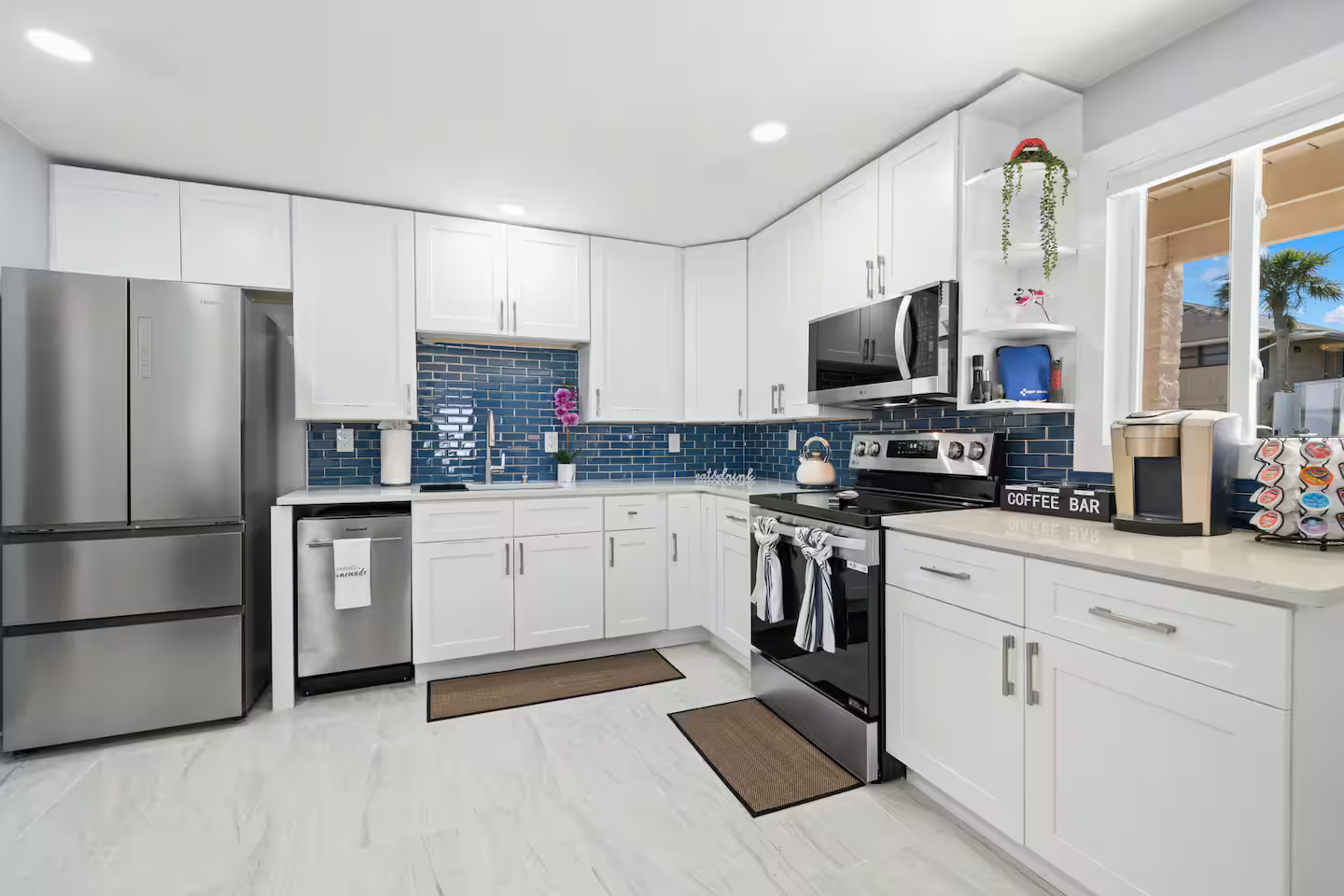 A kitchen with white cabinets and stainless steel appliances.