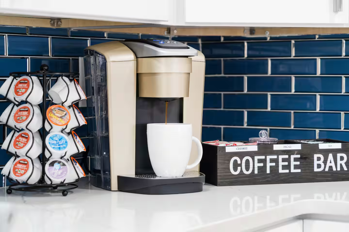 A coffee maker is sitting on a counter next to a coffee bar.