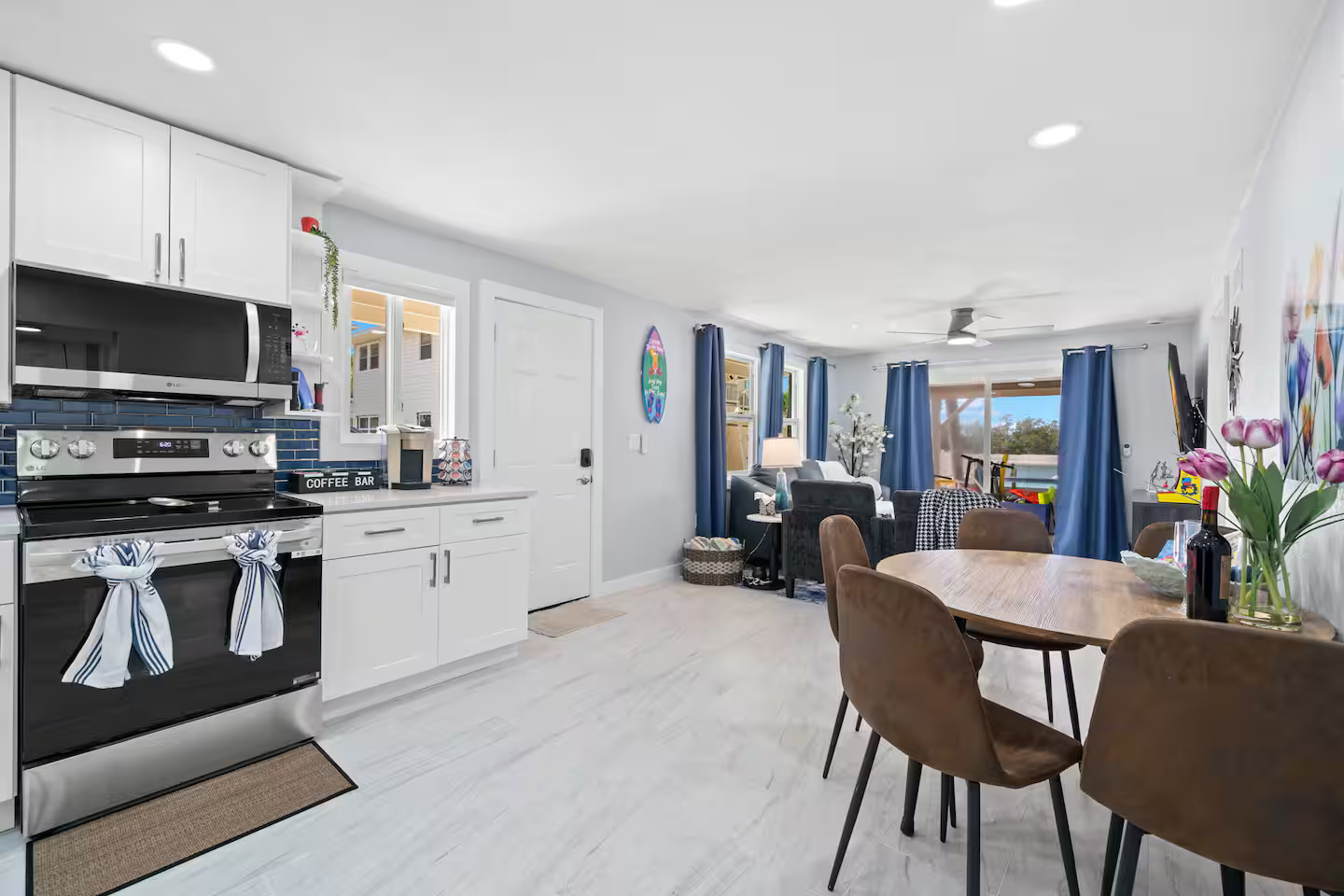 A kitchen and dining room in a house with a table and chairs.
