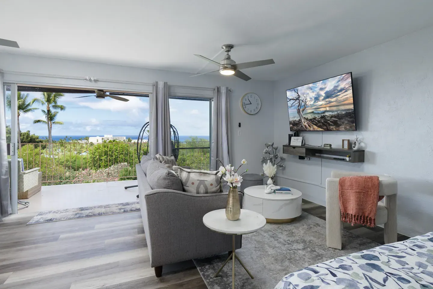A living room with a couch , chair , table and television.