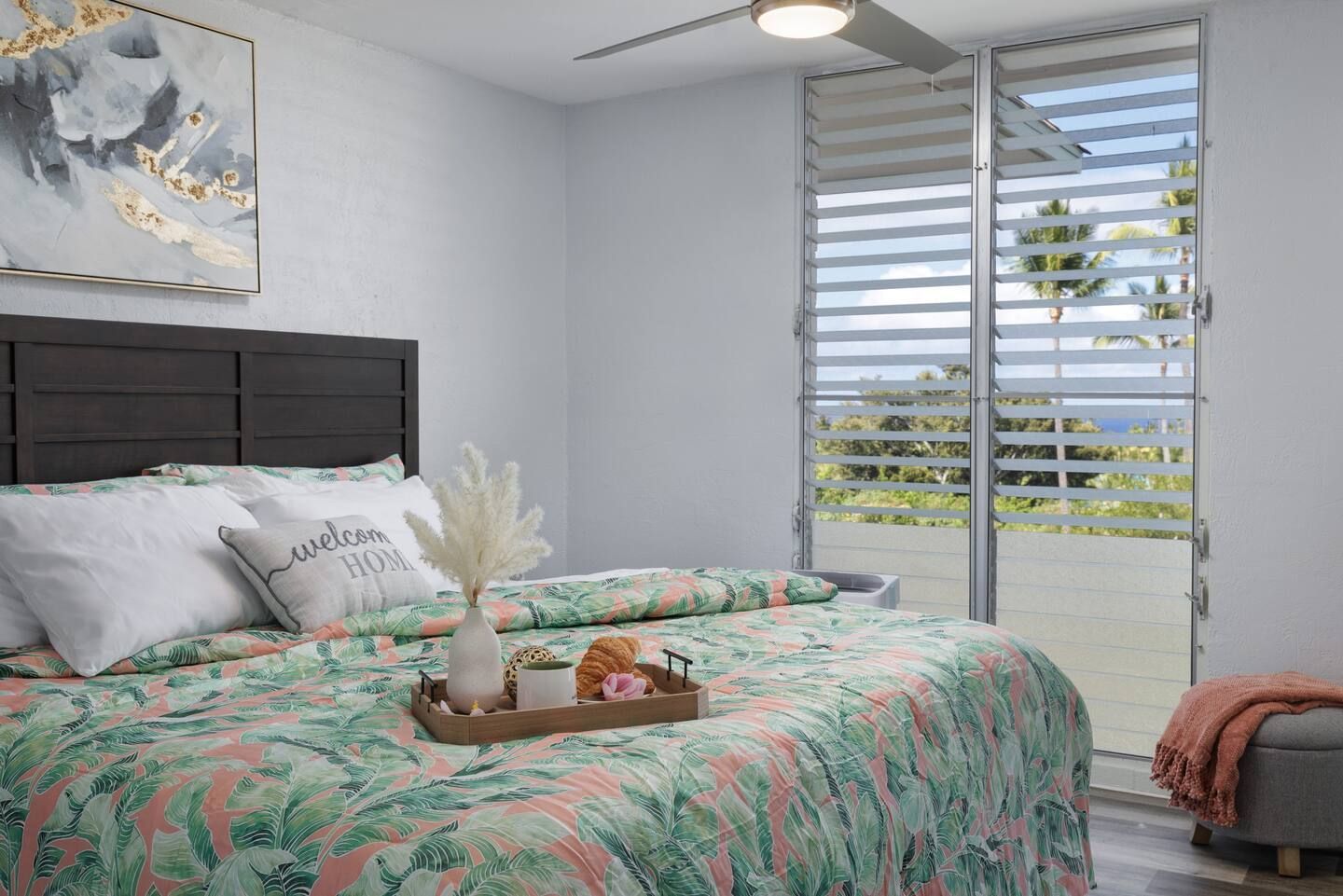 A bedroom with a king size bed and a tray on the bed.