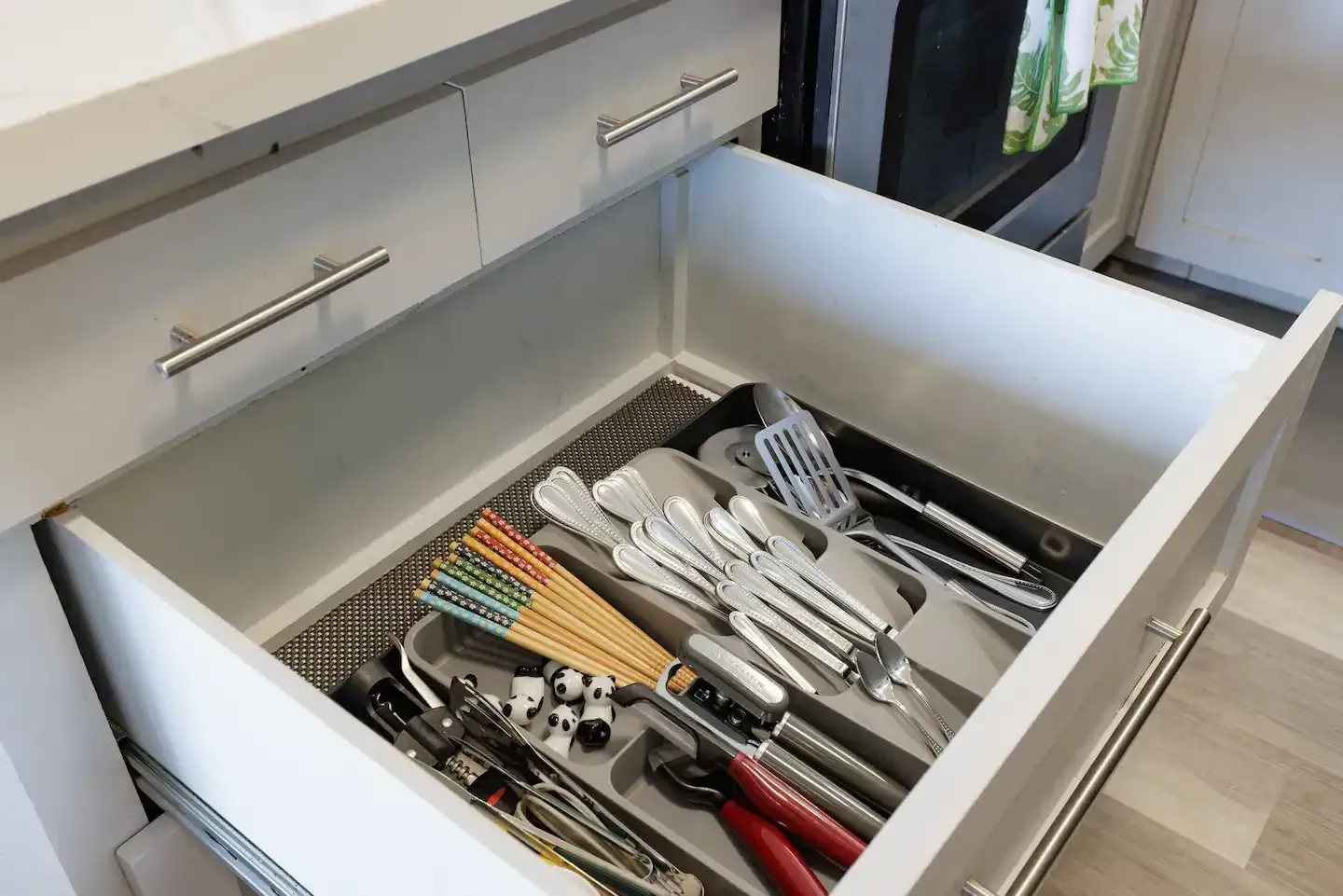 A kitchen drawer filled with utensils and tools