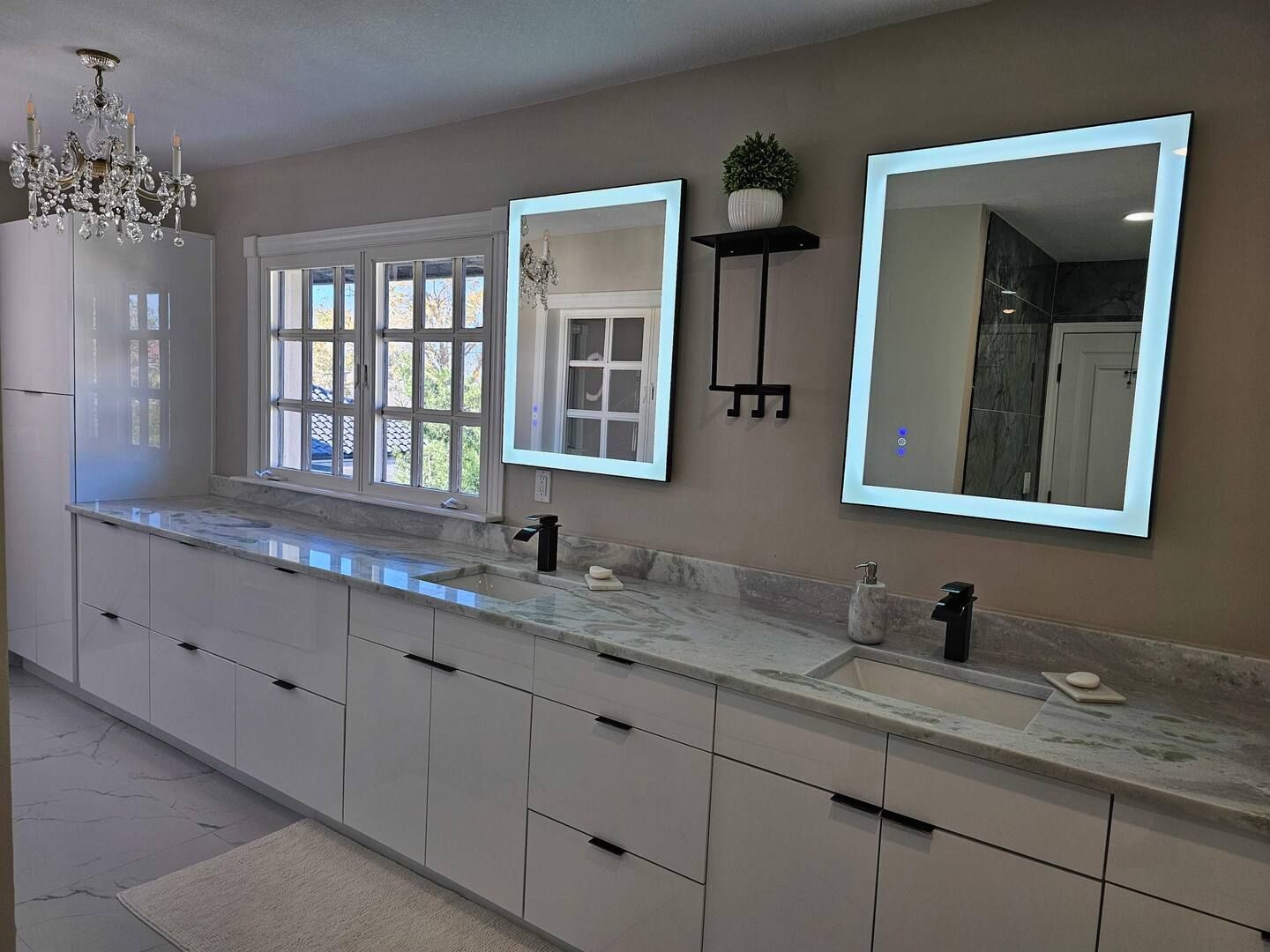 A bathroom with two sinks and two mirrors.