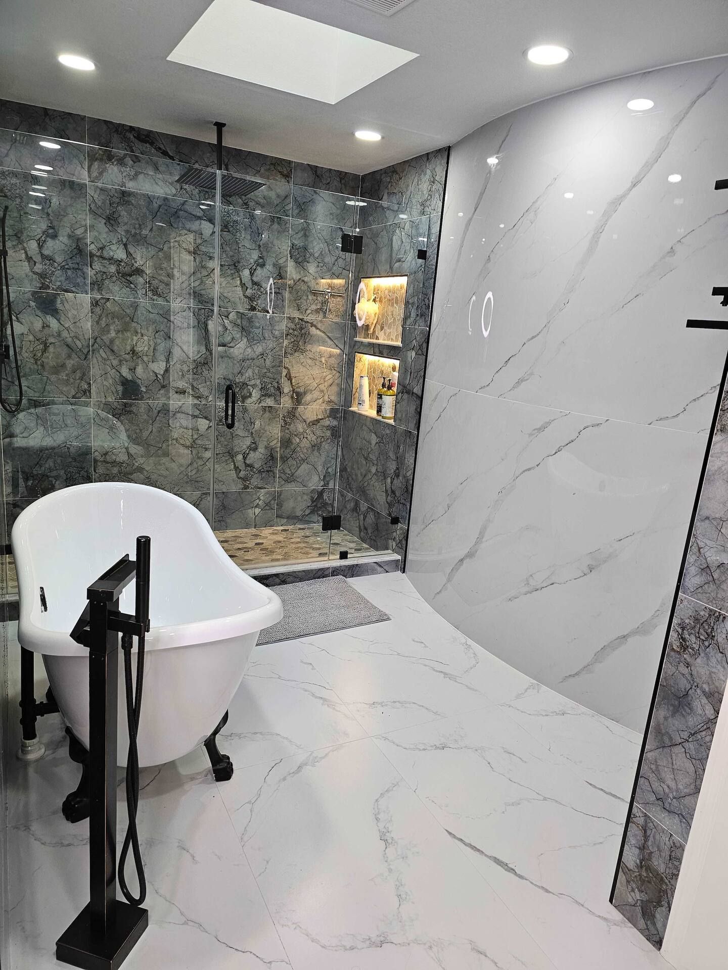 A bathroom with a bathtub and a walk in shower.