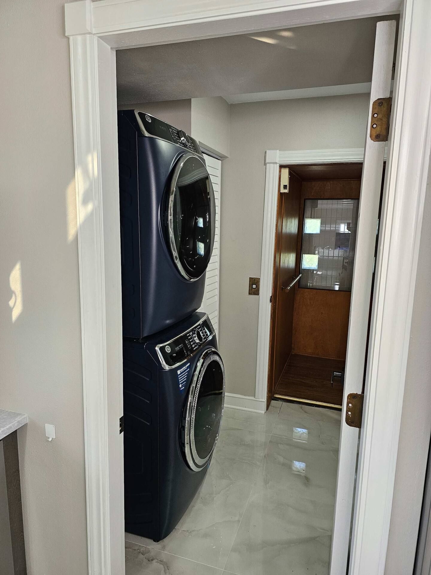 A washer and dryer are stacked on top of each other in a laundry room.