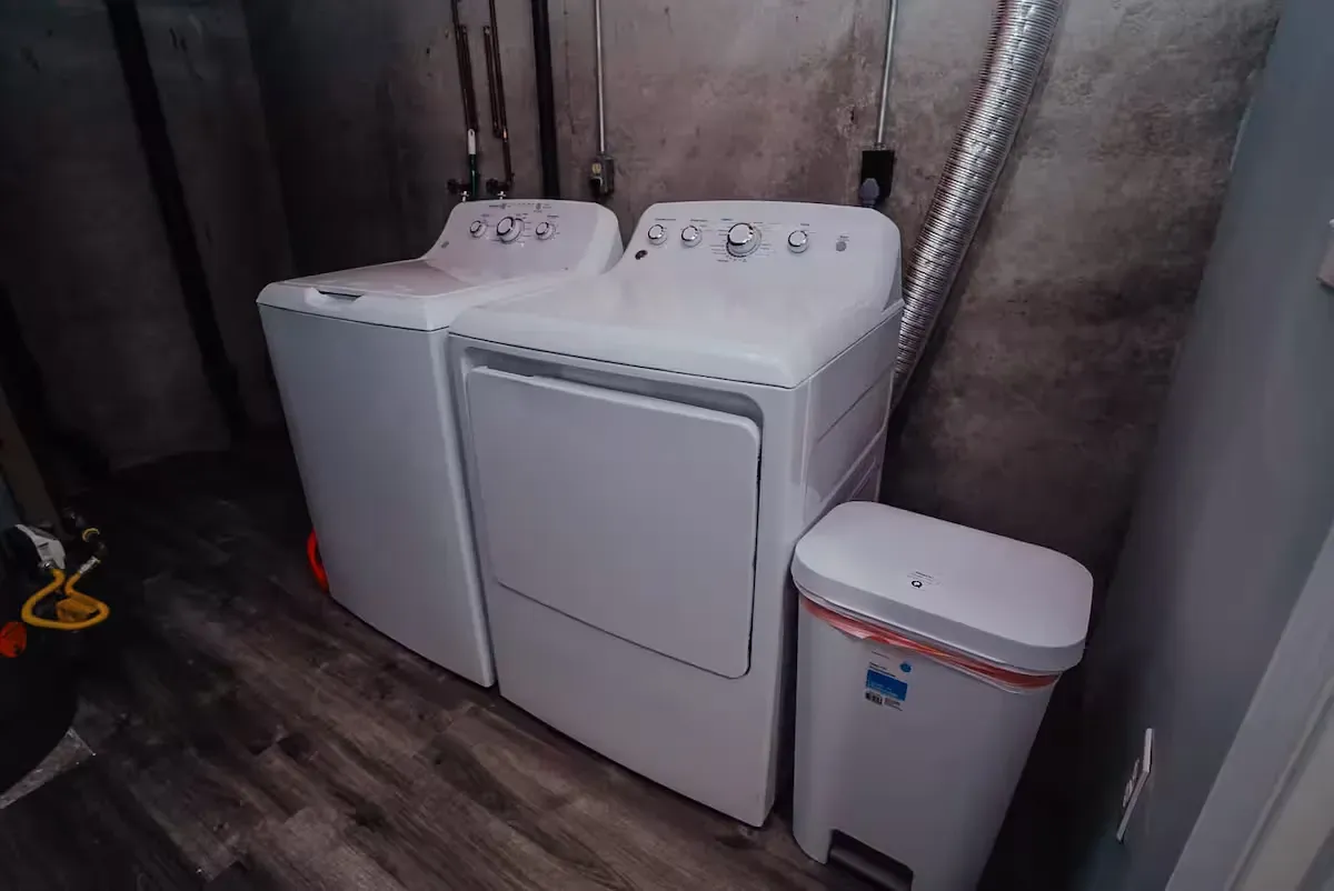 A washer and dryer are sitting next to each other in a laundry room.