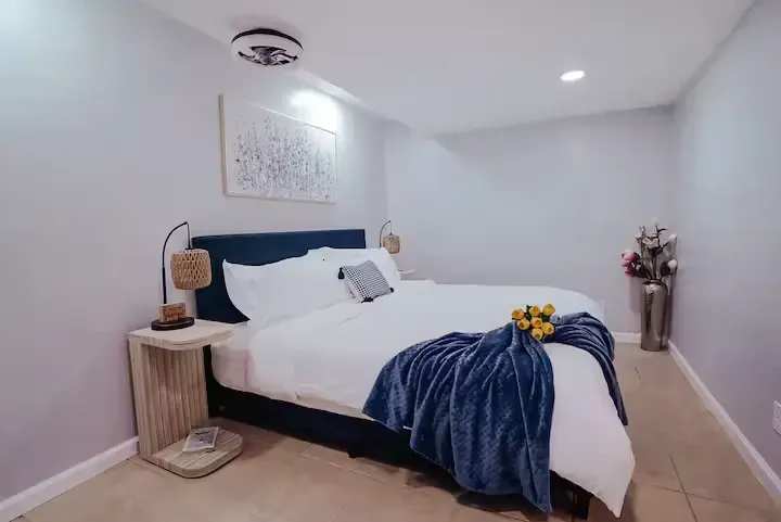 A bedroom with a king size bed and a nightstand.