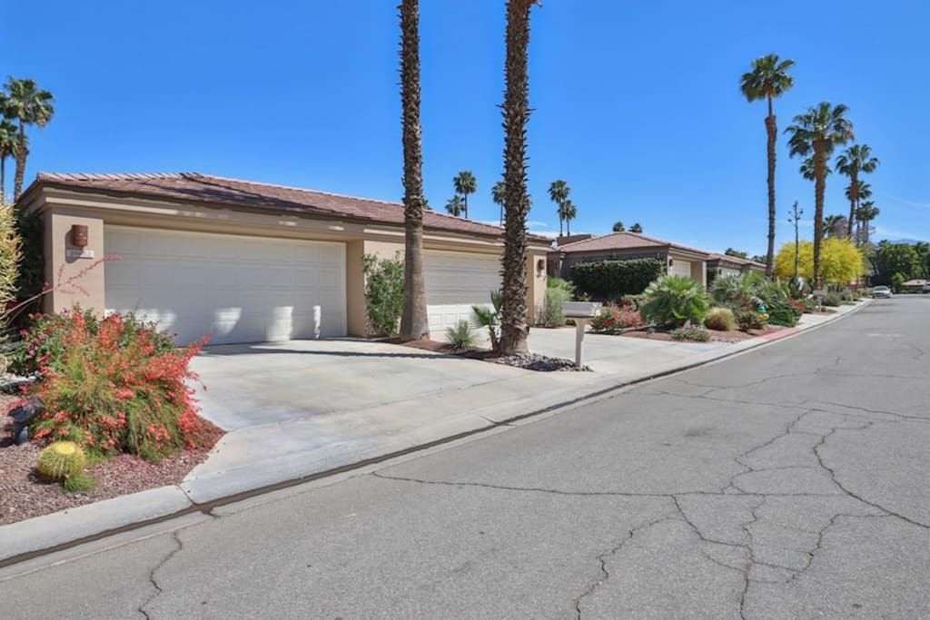 A house with a garage and palm trees in front of it- California- Trip- Summer