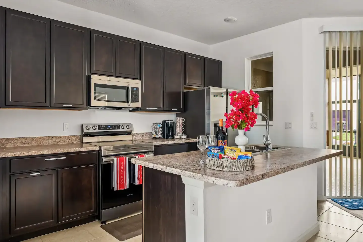 A kitchen with stainless steel appliances and granite counter tops.