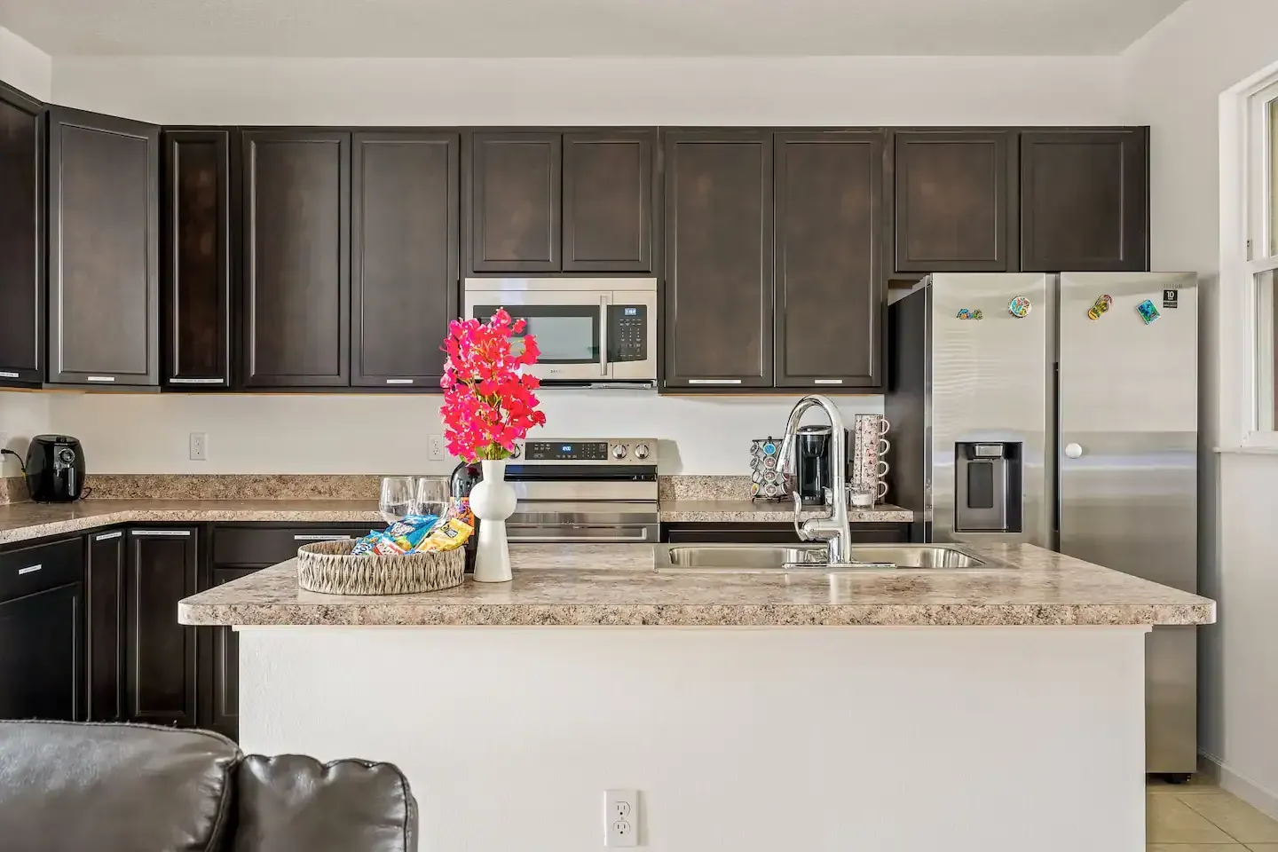 A kitchen with stainless steel appliances and granite counter tops.