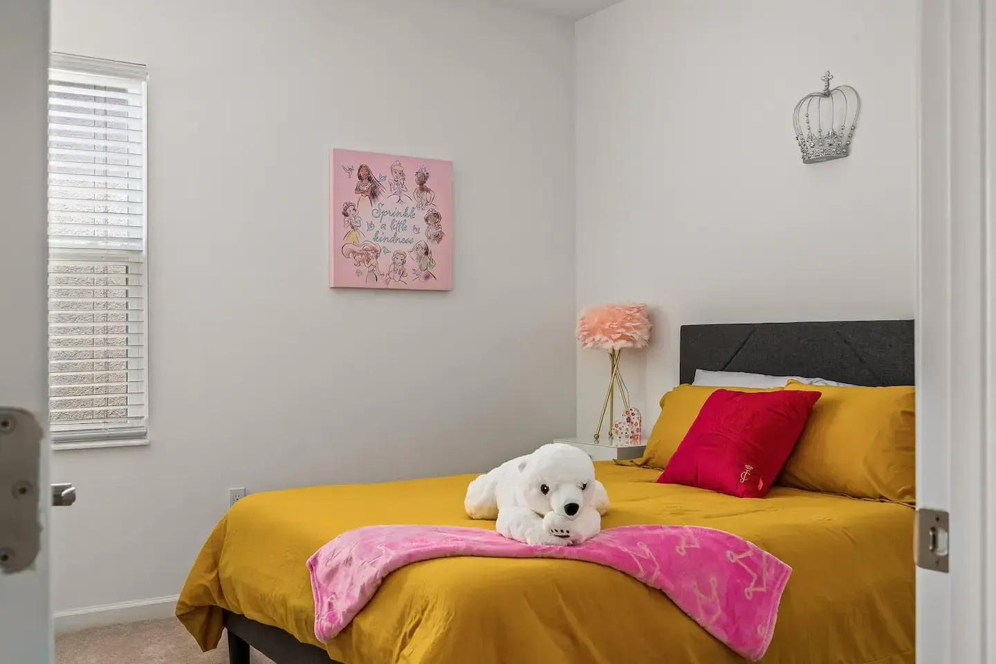 A bedroom with a bed and a stuffed animal on it.