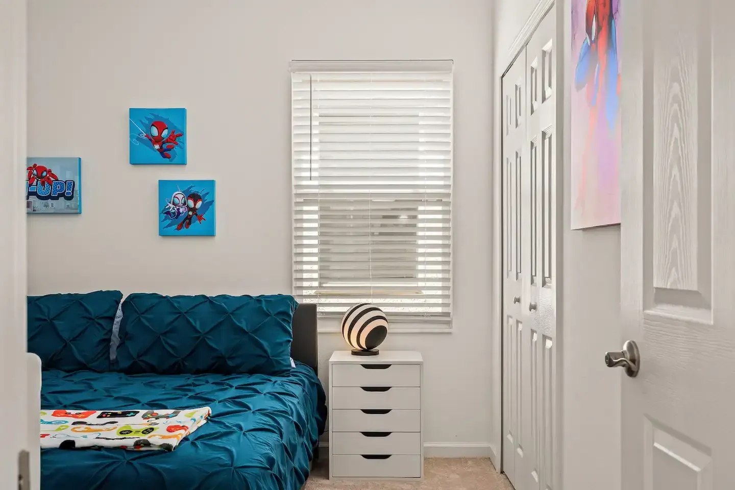 A bedroom with a bed , nightstand , and window.