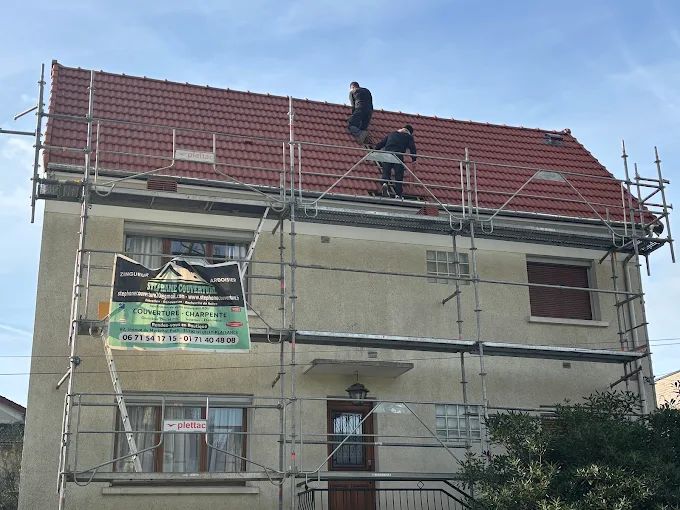 Deux couvreurs sur un toit.