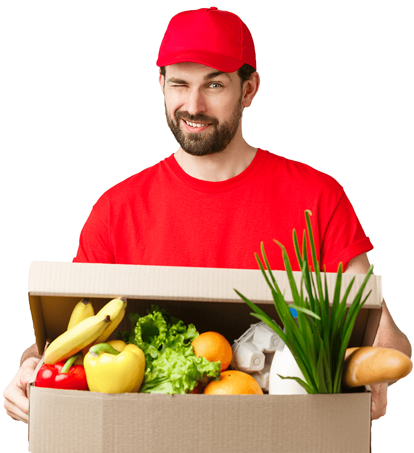 Un livreur portant un carton rempli de fruits et de légumes