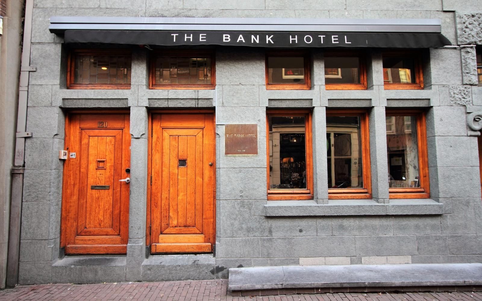 The front of the bank hotel with wooden doors and windows