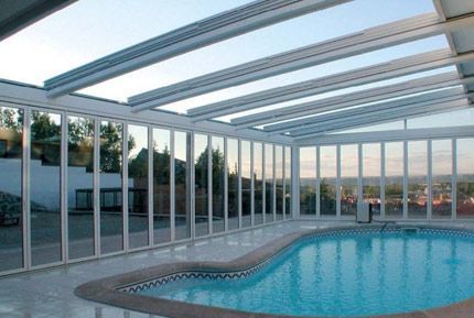 Una gran piscina cubierta con techo de cristal.