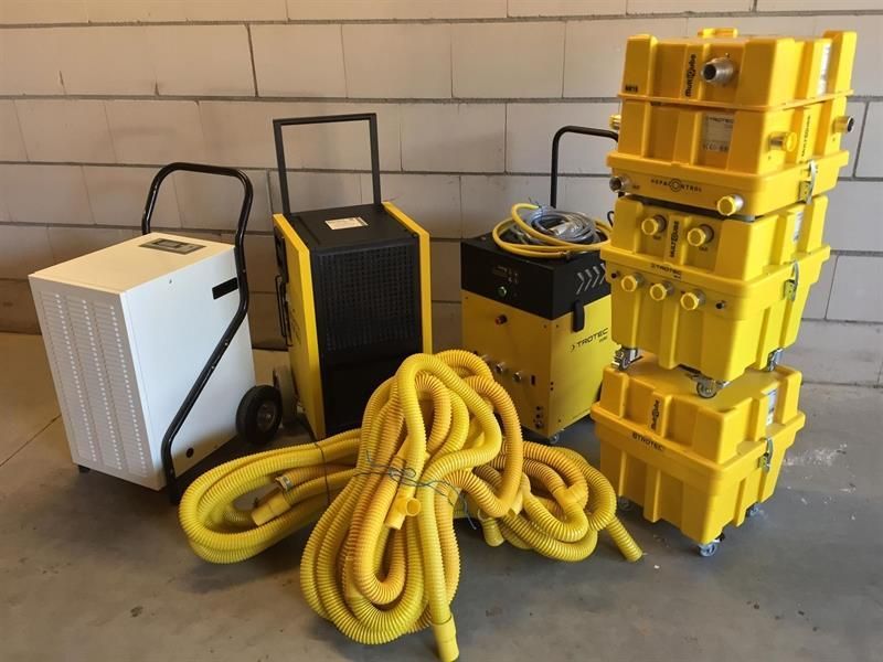 Ein Stapel gelber Kisten neben einem gelben Schlauch