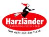 Logo: Witch on broom above 