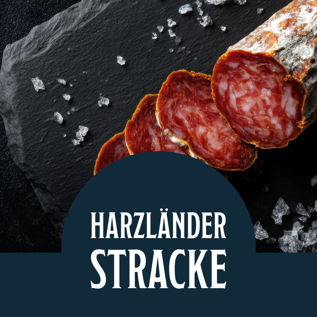 Aufgeschnittene Salami mit der Aufschrift „HARZLÄNDER STRACKE“ auf dunklem Hintergrund mit Salzkristallen.